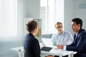 A group of people sitting at a table talking.