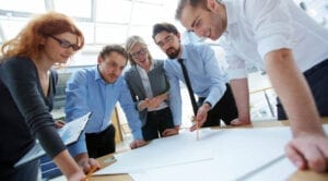 A group of people standing around a table.
